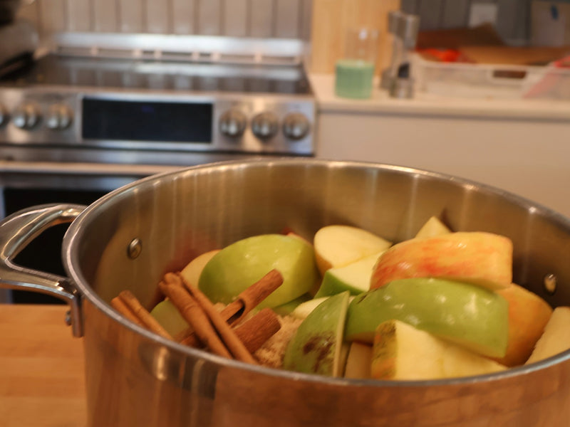 Quartered apples in a large stockpot on the stove