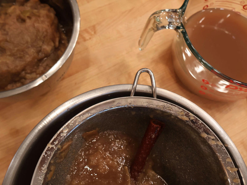Dark apple cider mixture in a stockpot after a long cook