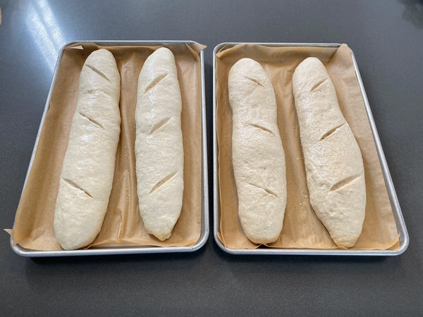 Shaped baguettes on parchment-lined sheet pans