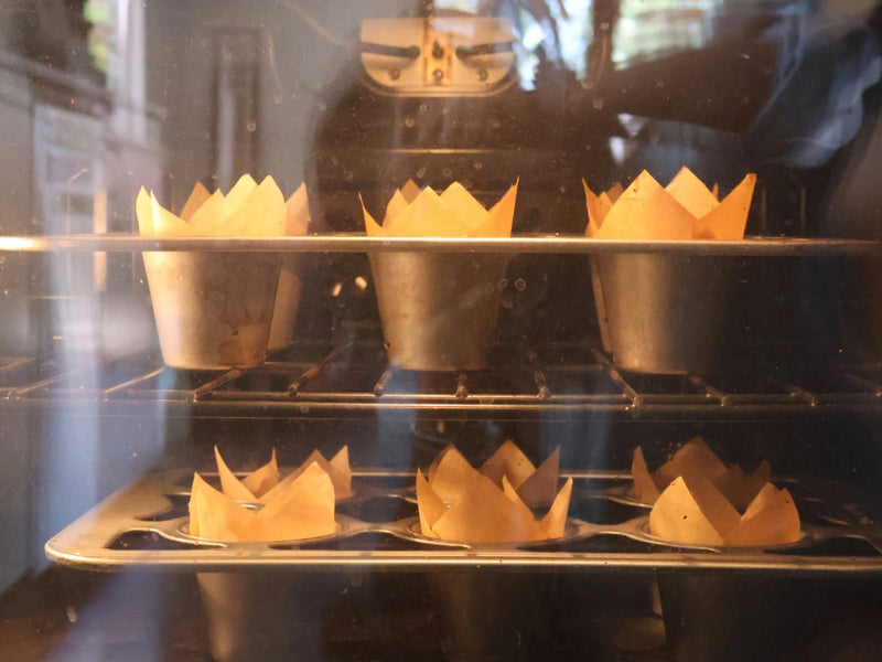 A batch of finished banana muffins arranged on a cooling rack