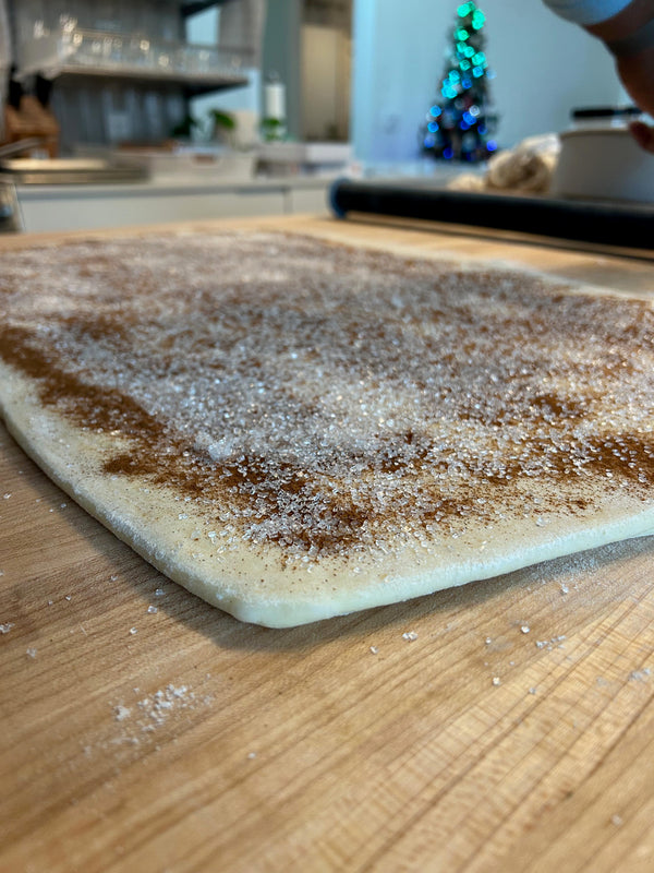 Dough rolled out and covered with cinnamon sugar