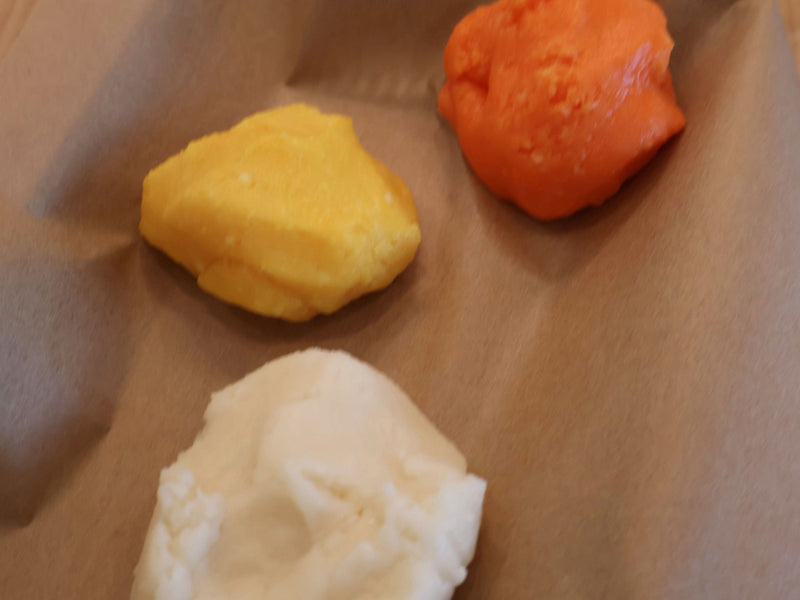 White orange and yellow portions of homemade candy corn dough