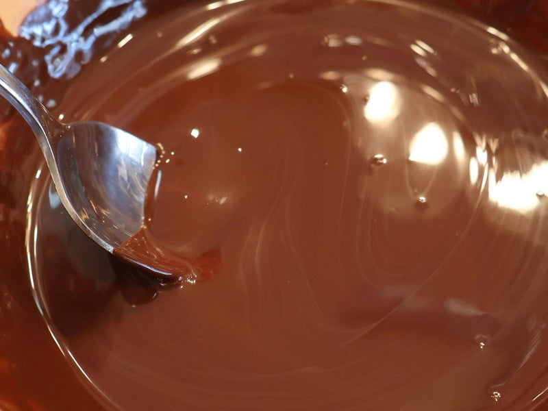 Smooth melted chocolate in a bowl for homemade fall bark