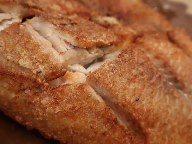 The full rack of fried and raw fish pieces side by side