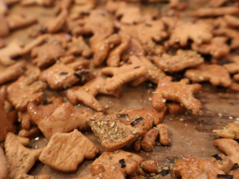 Furikake animal crackers spread across a baking sheet