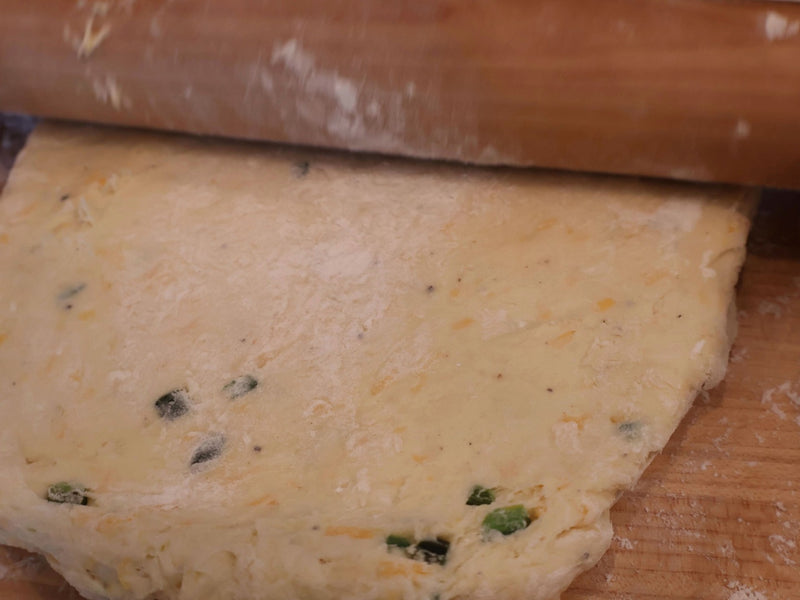 Jalapeño cheddar biscuit dough being folded