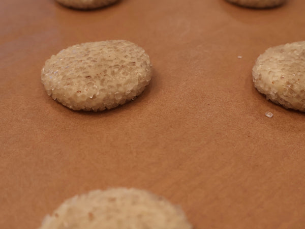 Scooped sandie cookies rolled in sugar