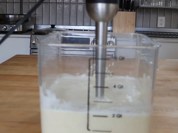 Straining through a nut milk bag